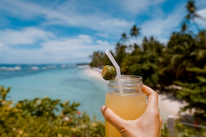 пальмы на пляже у моря, морской горизонт, коктейль на фоне пляжа 
