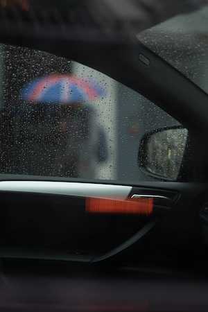 Зонтик от дождя в окне автомобиля