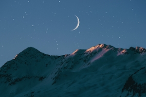луна и звезды в небе над горами 