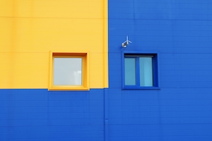 желто-синяя стена, окна, яркий фасад здания 
