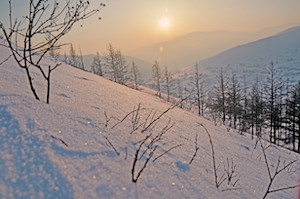 солнце на закате на снежном склоне 