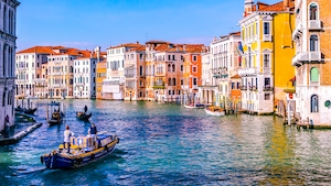 Канал в Венеции на днем, здания на воде, гондола с гондольером 