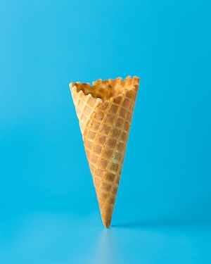 пустой рожок от мороженого на голубом фоне