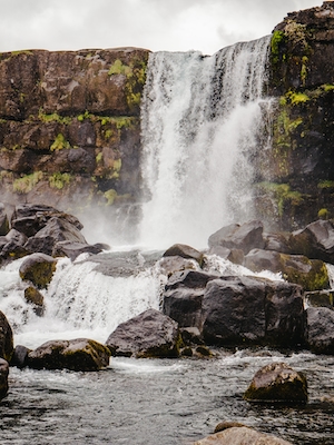 Стремительный водопад в Исландии, большой водопад, высокая отвесная скала 
