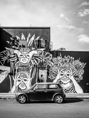 граффити на стене, черная машина у здания, черно-белая фотография 