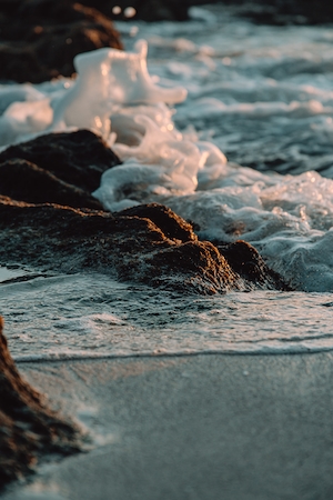 морская пена на скалах пляжа 