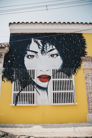 граффити, портрет девушки на желтой стене 