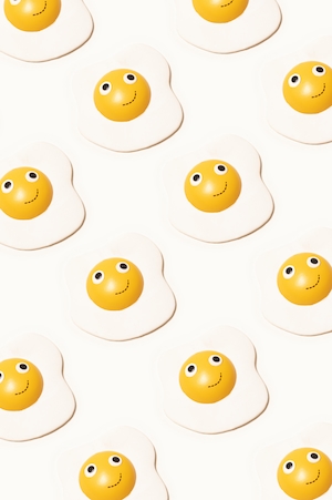 улыбающиеся игрушечные яйца на белом фоне